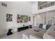 Light-filled living room with a high ceiling, modern decor, and a comfortable gray sectional sofa at 1551 Gateway Ln, Kissimmee, FL 34746