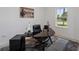 Modern home office with black desk, chair, and sleek furnishings at 1551 Gateway Ln, Kissimmee, FL 34746
