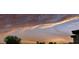 Dramatic clouds and sunset over green field with partial view of nearby home at 1551 Gateway Ln, Kissimmee, FL 34746