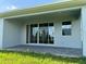 View of back porch with stone pavers and sliding glass doors at 1646 Pinecliff Dr, Apopka, FL 32703