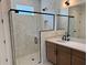 Modern bathroom with glass shower, black fixtures, and single sink vanity at 1646 Pinecliff Dr, Apopka, FL 32703