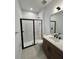 Sleek bathroom featuring a tiled shower with glass door and modern vanity at 1646 Pinecliff Dr, Apopka, FL 32703