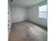 Carpeted bedroom with a window providing natural light at 1646 Pinecliff Dr, Apopka, FL 32703