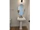 Stylish half bath features a pedestal sink with matte black fixtures at 1646 Pinecliff Dr, Apopka, FL 32703