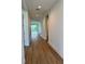 Bright hallway with wood-look flooring and neutral walls leading to other rooms at 1646 Pinecliff Dr, Apopka, FL 32703