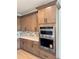 Modern kitchen featuring sleek wood cabinets, stainless steel appliances, and stylish backsplash at 1646 Pinecliff Dr, Apopka, FL 32703