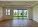Bright living room with expansive sliding glass doors and wood flooring at 1646 Pinecliff Dr, Apopka, FL 32703