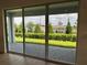 Patio view showcases landscaped backyard, patio pavers, and covered porch at 1646 Pinecliff Dr, Apopka, FL 32703