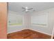 Bright bedroom featuring two large windows, ceiling fan and hardwood floors at 1753 Nw 44Th St, Ocala, FL 34475