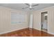 Bedroom with a window, ceiling fan, and a doorway view to the bathroom at 1753 Nw 44Th St, Ocala, FL 34475