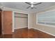 Cozy bedroom features wood floors, neutral walls, and a built-in closet for easy storage at 1753 Nw 44Th St, Ocala, FL 34475