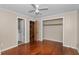 Cozy bedroom offering wood floors, a ceiling fan, and closet storage at 1753 Nw 44Th St, Ocala, FL 34475