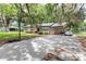 Charming single-story home featuring a large driveway, carport, and a well-manicured front yard shaded by mature trees at 1753 Nw 44Th St, Ocala, FL 34475