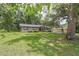 A cozy single-story house on a spacious lot, surrounded by mature trees offering plenty of shade and curb appeal at 1753 Nw 44Th St, Ocala, FL 34475