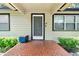 Welcoming front porch features colorful tile, mature landscaping and a charming bench for relaxing at 1753 Nw 44Th St, Ocala, FL 34475