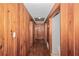 Wood paneled hallway featuring hardwood floors and access to multiple rooms at 1753 Nw 44Th St, Ocala, FL 34475