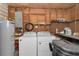 Functional laundry room features a water heater, washer, dryer, and storage shelves at 1753 Nw 44Th St, Ocala, FL 34475