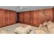Charming living room featuring wood paneling, a ceiling fan, and warm lighting at 1753 Nw 44Th St, Ocala, FL 34475