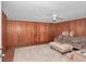 Comfortable living room with wood paneling, ceiling fan, and plush seating area at 1753 Nw 44Th St, Ocala, FL 34475