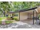 Exterior view showcasing a single-story home with a convenient carport, and well-maintained landscaping, offering comfort and style at 1753 Nw 44Th St, Ocala, FL 34475