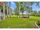Spacious backyard featuring a fire pit area surrounded by well-maintained green grass at 195 River Village Drive, Debary, FL 32713