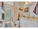 Bathroom including shower, sink, and outdoor access to the veranda at 195 River Village Drive, Debary, FL 32713