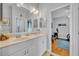 Bathroom featuring double sinks, plenty of counter space and a view into the exercise room at 195 River Village Drive, Debary, FL 32713