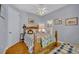 Cozy bedroom with wood-look floors, ceiling fan, comfy bedding, and ensuite bathroom at 195 River Village Drive, Debary, FL 32713