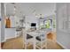 Open concept dining area between kitchen and living room featuring white table and chairs at 195 River Village Drive, Debary, FL 32713