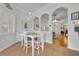 Bright dining area featuring white table and chairs, tile flooring and three pendant lights at 195 River Village Drive, Debary, FL 32713