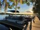 Picturesque view of a boat dock at sunset featuring pontoon boats and the golden light reflecting on the water's surface at 195 River Village Drive, Debary, FL 32713
