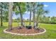 Fire pit nestled among lush trees with chairs for relaxing outdoor gatherings at 195 River Village Drive, Debary, FL 32713