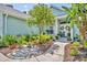 Front entrance showcasing a stone walkway and lush flower beds at 195 River Village Drive, Debary, FL 32713