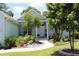 Charming single-story home with a beautifully landscaped yard and a welcoming walkway to the front door at 195 River Village Drive, Debary, FL 32713