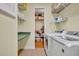 Convenient laundry room with storage and shelving and access to an additional closet at 195 River Village Drive, Debary, FL 32713