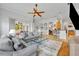 Open-concept living room with tile flooring, ceiling fan, and lots of natural light at 195 River Village Drive, Debary, FL 32713