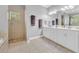 The main bathroom boasts double sinks, white cabinets, and a glass enclosed shower at 195 River Village Drive, Debary, FL 32713