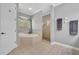 Beautiful main bathroom with large soaking tub, enclosed glass shower, and tiled floors at 195 River Village Drive, Debary, FL 32713