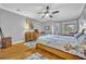 Another view of the expansive main bedroom features wood floors, neutral paint, and a ceiling fan at 195 River Village Drive, Debary, FL 32713