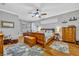 Spacious main bedroom with a large window, a ceiling fan, and wood floors at 195 River Village Drive, Debary, FL 32713