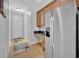 Bright mudroom with stainless steel refrigerator, lots of storage, and easy access to the front door at 195 River Village Drive, Debary, FL 32713