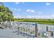 Outdoor bar on the deck with seating overlooking the water and natural landscape at 195 River Village Drive, Debary, FL 32713