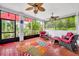 Covered veranda with red tile flooring and outdoor seating at 195 River Village Drive, Debary, FL 32713
