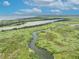 Panoramic water view showcases a meandering river flowing through lush green wetlands under a beautiful blue sky at 195 River Village Drive, Debary, FL 32713