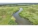 Scenic view of river flowing through lush wetlands and marsh, creating a picturesque natural landscape under a sunny sky at 195 River Village Drive, Debary, FL 32713