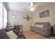 Bedroom with hardwood floors, natural light from a large window, and comfortable seating at 200 Hummingbird Ln, Longwood, FL 32779