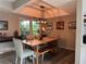 Cozy dining room featuring wood floors, a rustic table, and modern light fixture at 200 Hummingbird Ln, Longwood, FL 32779