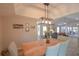 Open dining area connected to the living room, featuring a stylish light fixture and views of the backyard at 200 Hummingbird Ln, Longwood, FL 32779