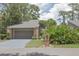 Charming brick home featuring an attached garage, mature landscaping, and a well-maintained front yard at 200 Hummingbird Ln, Longwood, FL 32779