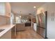 Open-concept kitchen with stainless steel appliances, white cabinets, a view to the dining and living areas at 200 Hummingbird Ln, Longwood, FL 32779